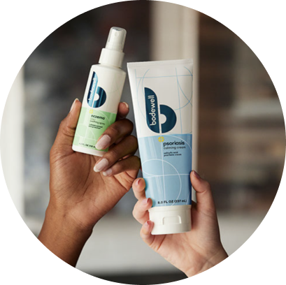 Close up of hands displaying Bodewell eczema and psoriasis skin care products.